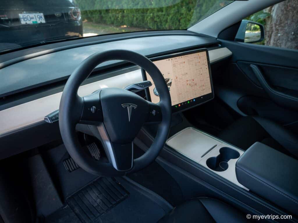 Tesla black interior with Hills wood grain dash