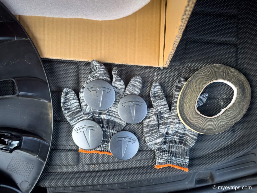 photo of tesla ceter caps, gloves, and a roll of protection packing tape for a set of Tesla Wheel Covers