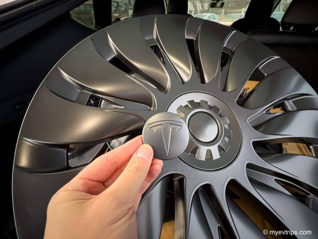 Center "T" cap in front of a set of Tesla model y uberturbine wheel covers