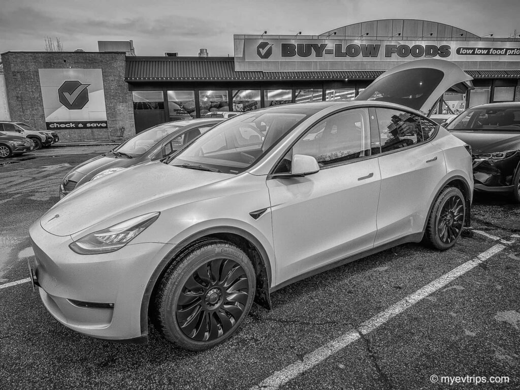 Black and white photo of Tesla model y with uberturbine wheel covers installed