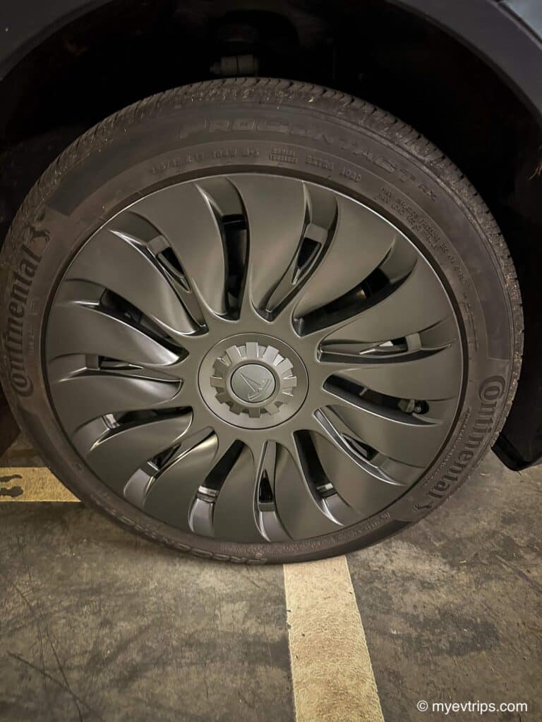 Close up of Tesla model y uberturbine wheel covers installed on a Model Y