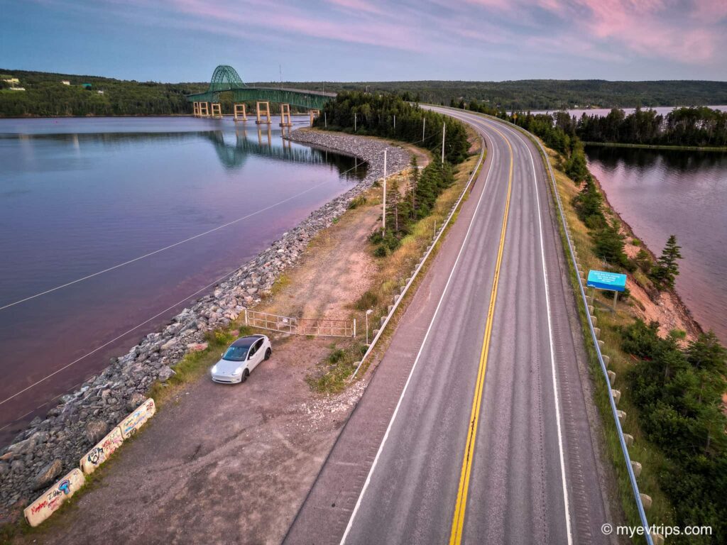 highway with bridge in background at sunset