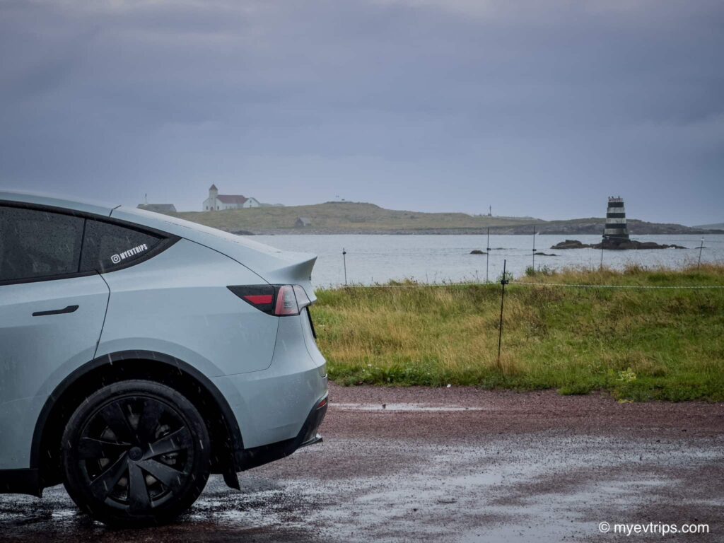 backend of Tesla Model Y with Île aux Marins in the background