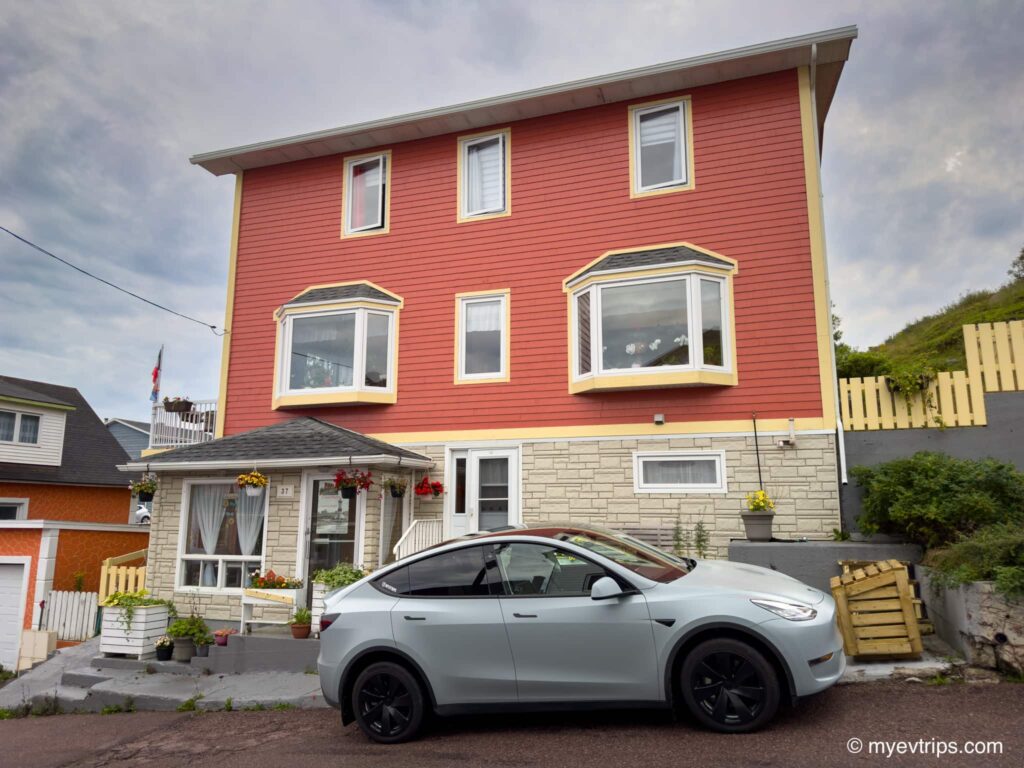 Tesla Model Y parking close to the Chez Marie Jo electrical outlet.