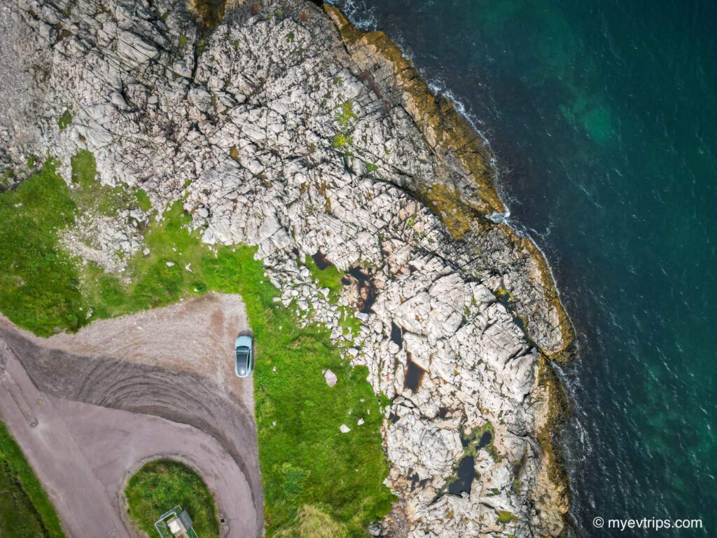 Arial shot of Saint Pierre shoreline with Tesla Model Y parked