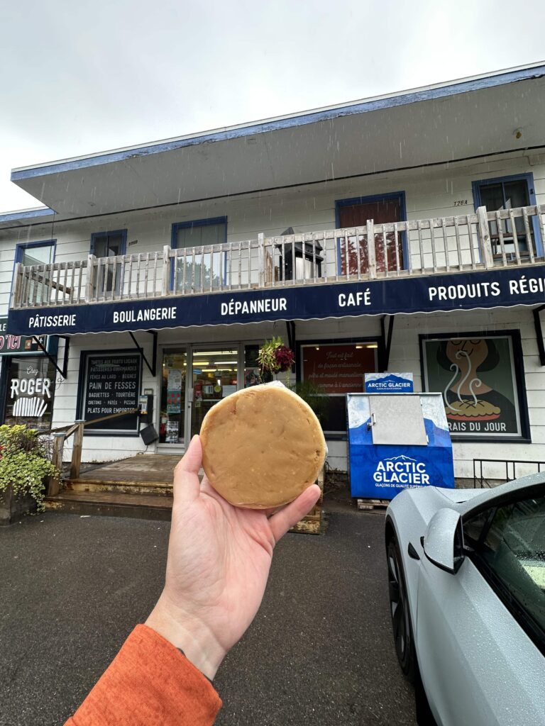 Hand holding up maple pastry from Chez Roger Boulangerie