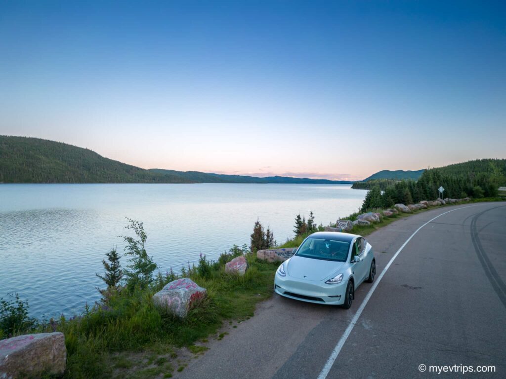 Tesla Model Y next to a lake on Quebec City to Baie-Comeau drive