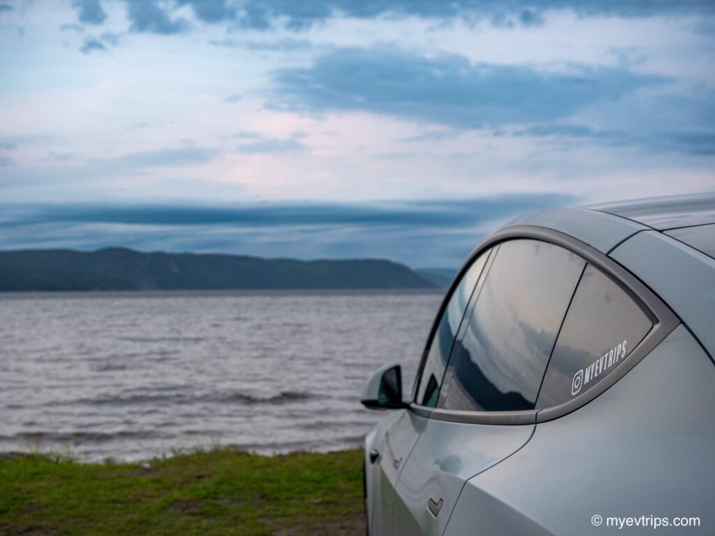 Tesla Model Y side view with Saguenay River in background
