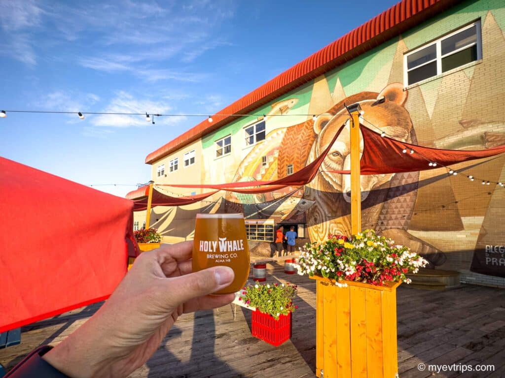 Holy Whale Beer Garden hand holding up beer