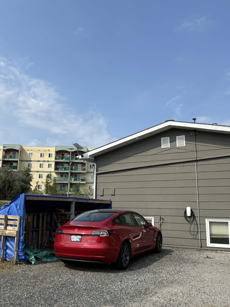 Red Tesla Model 3 parked at home in Yellowknife shows Electric vehicles in Canada are everywhere