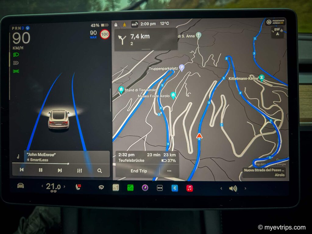 Tesla Model 3 screen with windy Swiss Alps EV Road Trip map displayed